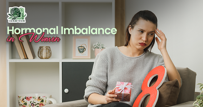 Woman sitting peacefully at home holding a warm herbal tea, reflecting on hormonal imbalance symptoms and natural ways to support hormone health