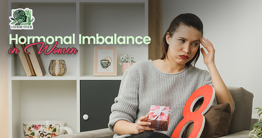 Woman sitting peacefully at home holding a warm herbal tea, reflecting on hormonal imbalance symptoms and natural ways to support hormone health
